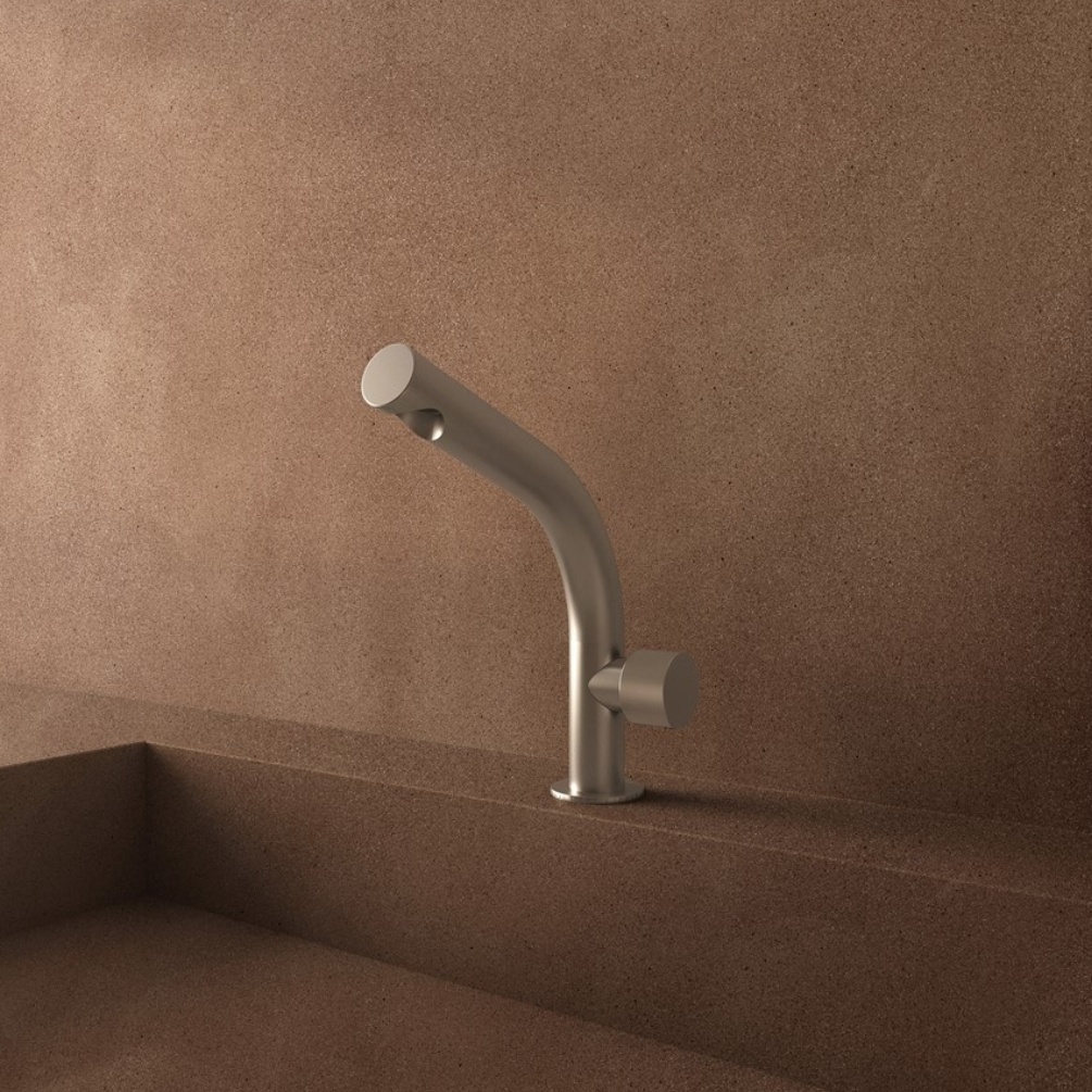 Lifestyle image of the Crosswater Ixora Stainless Steel Basin Mixer Tap installed on the deck of basin